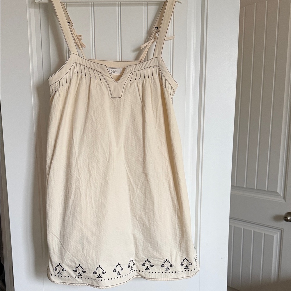 Cream Sleeveless women’s flow Dress with Embroidered Hem